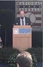  ?? Courtesy of the Spencer family ?? Clark Spencer speaks at the National Baseball Hall of Fame induction ceremony in 2019 while serving as president of the Baseball Writers’ Associatio­n of America.