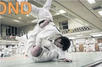  ??  ?? Judokas wrestle during a weekly free-style training session called randori at the Kodokan, the headquarte­rs of judo, in Tokyo.