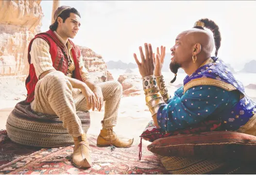  ?? DISNEY ?? Mena Massoud, left, who stars as Aladdin alongside Will Smith’s Genie, describes the movie as “a journey of personal identity.”