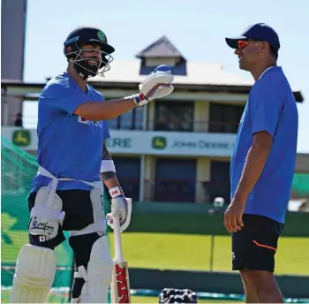  ?? — BCCI ?? India captain Virat Kohli (left) interacts with coach Rahul Dravid at a training session in Centurion on Saturday, the eve of their first Test against South Africa.