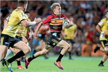  ?? GETTY IMAGES ?? Damian McKenzie races away for a try during the Super Rugby match between the Chiefs and the Hurricanes in Hamilton on Friday. McKenzie has been given permission to play six games in a row.