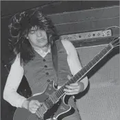  ?? Michael Putland Getty Images ?? BRASH GUITAR RIFFS Malcolm Young performs with AC/DC in 1976. He was the primary writer of most of the group’s hits.