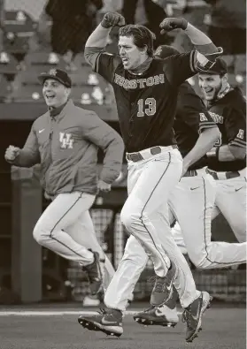  ?? Brett Coomer / Staff photograph­er ?? Tyler Bielamowic­z celebrates as he rounds the bases after hitting a walk-off solo home run off Texas reliever Aaron Nixon in the 11th inning of Saturday’s game at Don Sanders Field at Schroeder Park.