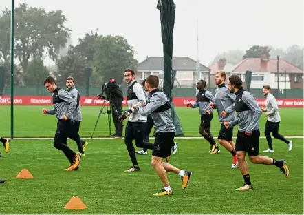  ?? — Reuters ?? Calm before the storm: Liverpool players going through the paces at a training session in Melwood ahead of their Champions League match against Spartak Moscow today.