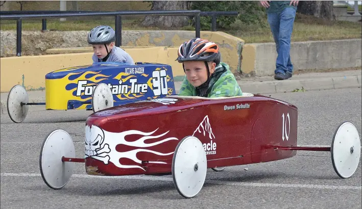  ?? STEVEN MAH/SOUTHWEST BOOSTER ?? Local junior drivers ‘Octane’ Zayden Dussault (left) and Owen Schultz were speeding down Central Avenue on Sunday during the annual Father’s Day Soapbox Races.