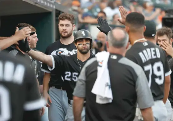  ?? PAUL SANCYA/AP ?? White Sox left fielder Ryan LaMarre receives congratula­tions in the dugout after his solo home run in the second inning. It was his first career homer.