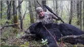  ?? CP HANDOUT COURTESY YOUTUBE-WEMI STUDIO ?? American Josh Bowmar, seen here in a still image made from video, poses with the spear and black bear he killed, which resulted in a public backlash. Spear-hunting is being banned in Alberta. The province says it is updating hunting rules to make sure...