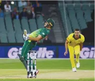  ?? (AFP) ?? South Africa’s David Miller (left) avoids a delivery from Australia’s Marcus Stoinis during the second ODI in Adelaide yesterday.