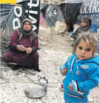  ?? FOR MICHAEL PETROU MIDDLE EAST PROJECT ?? A family living in the informal tent settlement in Lebanon’s Beqaa Valley. Some children in the camp have developed respirator­y problems because of the dampness and lack of hygiene.