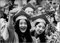  ?? LI MUZI / XINHUA ?? Several Chinese students cheer at Colombia University graduation ceremonies last year in New York City.