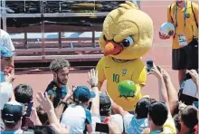  ?? ASSOCIATED PRESS FILE PHOTO ?? Brazil’s mascot holds a soccer ball while fans cheer the team’s Neymar as he leaves a training session in Sochi, Russia, last month.