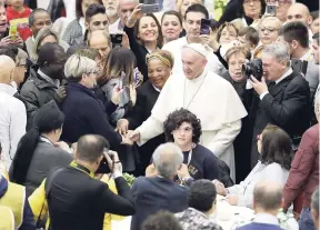  ?? AP ?? Pope Francis greets people as he arrives at the Vatican yesterday. Pope Francis offered several hundred poor, homeless, migrants and unemployed people lunch on Sunday as he celebrated the World Day of the Poor with a concrete gesture of charity in the spirit of his namesake, St Francis of Assisi.