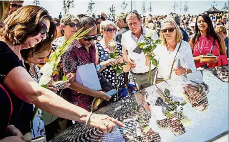  ??  ?? Thinking of you: Relatives attending the unveiling of the MH17 monument in Vijfhuizen. — AFP