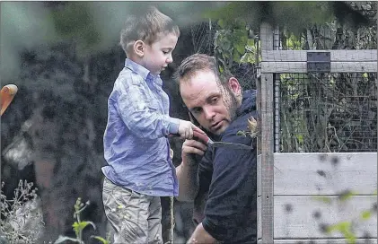  ?? CP PHOTO ?? Joshua Boyle and his son Jonah play in the garden at the home of his parents in Smiths Falls, Ont., on Saturday. Boyle, who along with his wife Caitlan Coleman were held hostage for five years by a Taliban-linked network and forced to raise three...