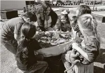  ?? Kin Man Hui / Staff photograph­er ?? Assistant teacher Monisha Fields gathers students around a sandbox at the Pre-K 4 SA South Education Center in February. Renewing Pre-K 4 SA will prepare more children for the future.