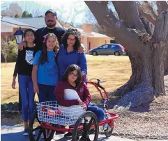  ?? BETHANY FREUDENTAL/LAS CRUCES SUN-NEWS ?? The Holguin family outside their home on Capri Arc in Mesilla on Feb. 21.