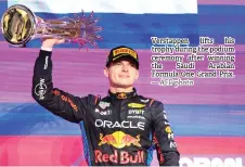  ?? — AFP photo ?? Verstappen lifts his trophy during the podium ceremony after winning the Saudi Arabian Formula One Grand Prix.