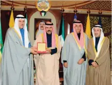  ??  ?? His Highness the Crown Prince Sheikh Nawaf Al-Ahmad Al-Jaber Al-Sabah receives a memorial specie from Informatio­n Minister Sheikh Salman Sabah Al-Salem Al-Humoud Al-Sabah, in presence of NCCAL officials Ali AlYouha and Mohammad Al-Asousi.