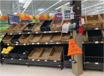  ?? (Special to The Commercial) ?? Store shelves at Walmart in Pine Bluff and at other grocery stores in the area were picked clean by shoppers.