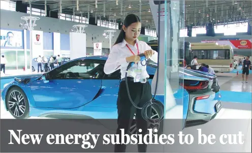  ?? WANG LUXIAN / FOR CHINA DAILY ?? An exhibitor prepares a charger for a new energy car at an energy conservati­on and new energy auto show in Nanjing, Jiangsu province, on Sept 7.