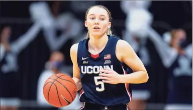  ?? Michael Conroy / Associated Press ?? UConn’s Paige Buckers has become one of the biggest celebritie­s in women’s basketball as her parents watch from afar in Minnesota.