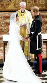  ?? — AP ?? Britain’s Prince Harry and Meghan Markle exchange vows during their wedding ceremony at St. George’s Chapel at Windsor Castle, near London, on Saturday.