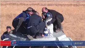  ?? Photograph: ROSCOSMOS/Reuters ?? Yulia Peresild is assisted out of the Soyuz capsule after returning from the Internatio­nal Space Station on Sunday.