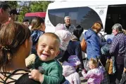  ?? ANDRIY ANDRIYENKO / AP ?? A Ukrainian woman Alyona, 20, holds her son Sergei, 1, as they wait for boarding during an evacuation of civilians in Kramatorsk, Ukraine, on Tuesday.