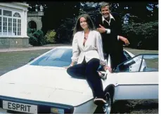  ??  ?? SUPERCAR FOR A SUPERSPY: Roger Moore, Barbara Bach and the Lotus Esprit in The Spy Who Loved Me