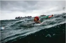  ?? — AFP photos ?? A woman using a life ring and Lau Sam-lan, 74 (right) swim off the western tip of Hong Kong Island.