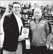  ?? FILE PHOTO ?? Lynn Gregson (left) was honored Nov. 27 as a community inductee into the Prairie Grove Hall of Pride. Prairie Grove athletic director Joey Sorters presented Gregson a plaque recognizin­g his contributi­ons to Tiger athletics as “the Voice of the Tigers”...