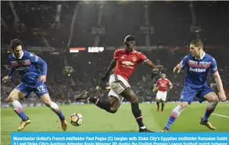  ??  ?? Manchester United’s French midfielder Paul Pogba (C) tangles with Stoke City’s Egyptian midfielder Ramadan Sobhi (L) and Stoke City’s Austrian defender Kevin Wimmer (R) during the English Premier League football match between Manchester United and...