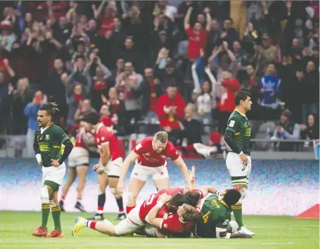  ?? THE CANADIAN PRESS/FILES ?? Canada’s Jake Thiel is mobbed by his teammates after Canada defeated South Africa during the bronze medal match at the Canada Sevens rugby tournament in Vancouver on March 8. Organizers at the event had taken such COVID-19 precaution­s as hand sanitizer stations.