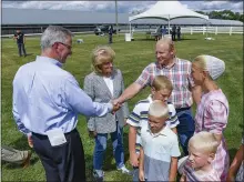  ??  ?? Pennsylvan­ia Secretary of Agricultur­e Russell C. Redding shakes hands with Jeremy Martin, while talking to Martin and his wife, Cindy, and their family. With them is state Sen. Judy Schwank. There was a celebratio­n Thursday at the Martins’ farm in Bethel Township as the state reached 600,000acres of farmland preserved.