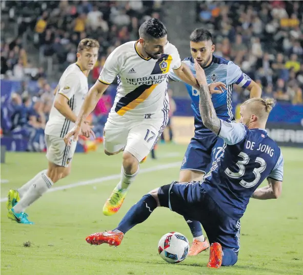  ?? — THE ASSOCIATED PRESS FILES ?? Whitecaps defender Marcel de Jong, right, played for Kansas City in 2015 and knows all about the rocking atmosphere that permeates Kansas City’s Children’s Mercy Park. Vancouver is looking for a CONCACAF Champions League win there Tuesday.