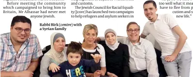  ??  ?? Rabbi Birk (centre) with a Syrian family