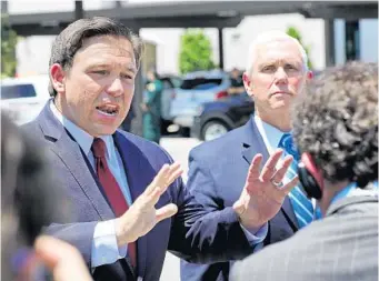  ?? JOE BURBANK/ORLANDO SENTINEL ?? Gov. Ron DeSantis answers reporters’ questions with Vice President Mike Pence on Wednesday at the Westminste­r Baldwin Park retirement community in Orlando. Pence and DeSantis visited the facility to help deliver supplies.