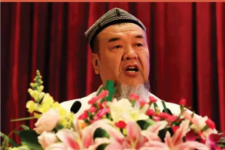  ??  ?? Abdureqip Tomurniyaz, who heads the associatio­n and the school for Islamic studies in Xinjiang, speaks during a government reception held for the Eid al-fitr festival in Beijing yesterday