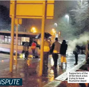  ??  ?? Supporters of the strike block a bus trying to leave Rusholme depot