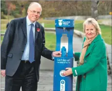  ?? Photograph: Gareth Easton Photograph­y. ?? Douglas Millican, chief executive of Scottish Water, and Roseanna Cunningham, Cabinet Secretary for the Environmen­t, Climate Change and Land, try out one of the new top-up taps.