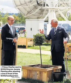  ?? Peter Nicholls ?? Prince Charles next to GCHQ Director Jeremy Fleming after planting a tree in front of the GCHQ headquarte­rs