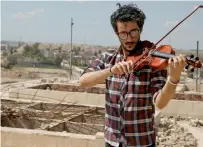  ?? Reuters ?? Ameen Mukdad performs at Nabi Yunus shrine in Mosul —
