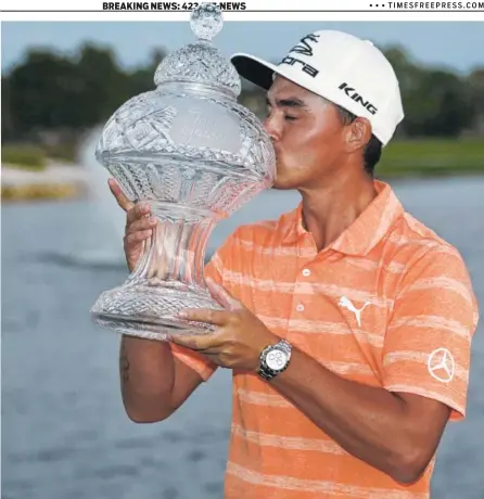  ??  ?? Rickie Fowler kisses the trophy after winning the Honda Classic on Sunday in Palm Beach Gardens, Fla. Fowler closed the tournament with a 1-over-par 71 for a four-shot win over Gary Woodland. It was Fowler’s fourth PGA Tour victory.