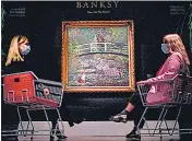  ?? AFP ?? The artwork titled Show me the Monet by street artist Banksy is seen during a photo call at Sotheby's in London.