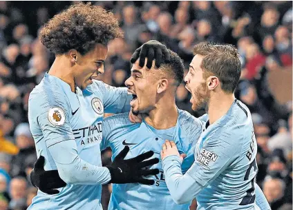  ??  ?? That’s my boy: Gabriel Jesus (centre) celebrates his opening goal with Leroy Sane (left) and Bernardo Silva