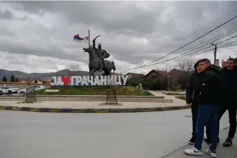  ?? — AFP file photos ?? Youth stand in front of a sign reading “I Love Gracanica” in the town of Gracanica, central Kosovo.