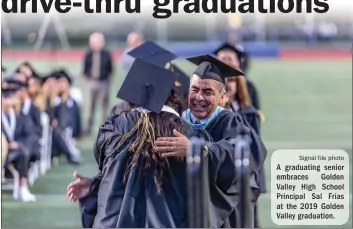  ?? Signal file photo ?? A graduating senior embraces Golden Valley High School Principal Sal Frias at the 2019 Golden Valley graduation.