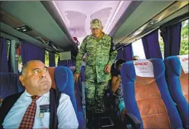  ??  ?? AUTHORITIE­S check IDs and search for migrants at a checkpoint near Comitan in Mexico. Journeys using a coyote can cost between $1,800 to $12,000 per person.