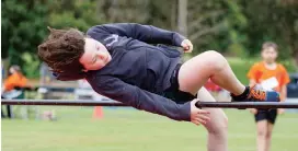  ??  ?? Riley McMillan competes in the high jump event.