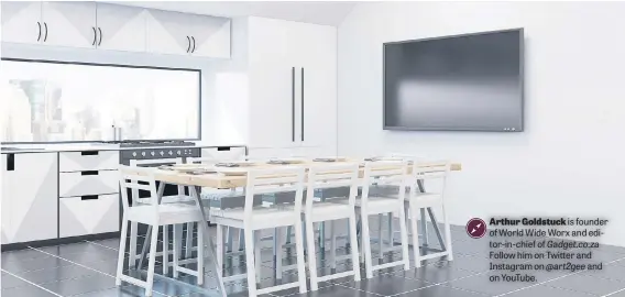  ??  ?? PRIME POSITION. Modern kitchen interior with white walls, fridge, stove and large dining table – with a TV in the family space.